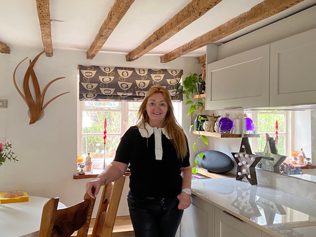 Ms McLean stands in the kitchen in the home she has transformed