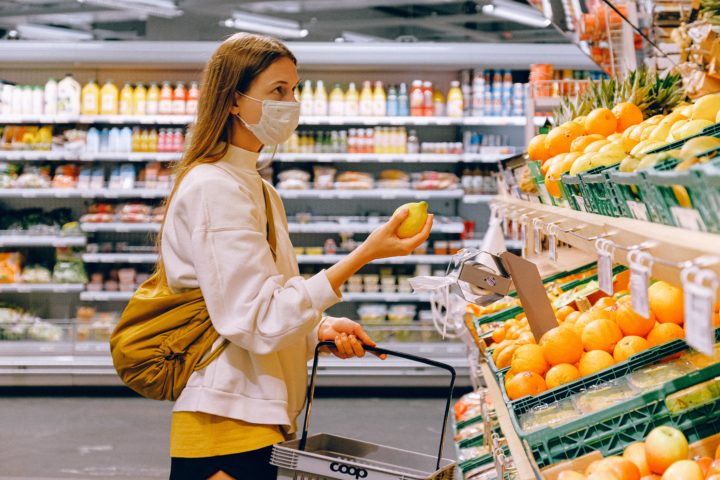 Lady in supermarket wearing mask
