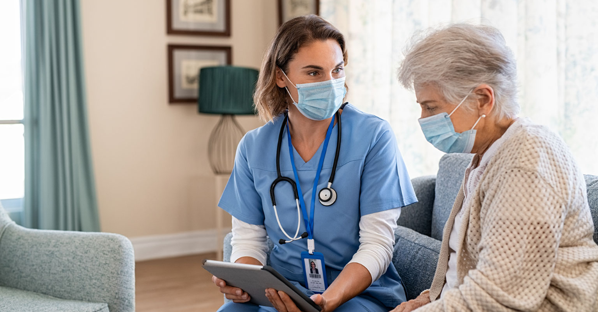 A picture of a health working talking to an elderly lady