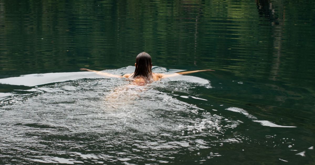 A photo of a person swimming in a river