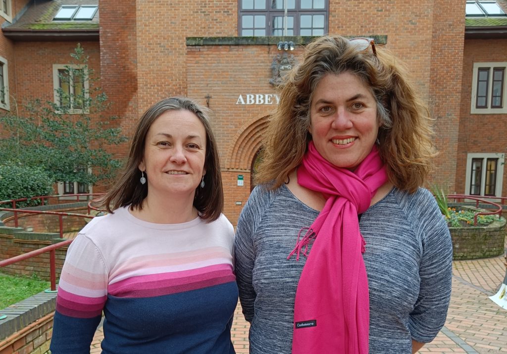 A photo of Cllr Emily Smith and new council leader Bethia Thomas standing outside Abbey House in Abingdon