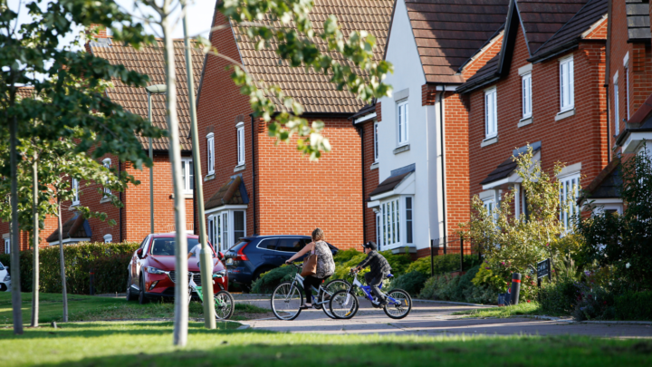An image of people cycling on a housing estate